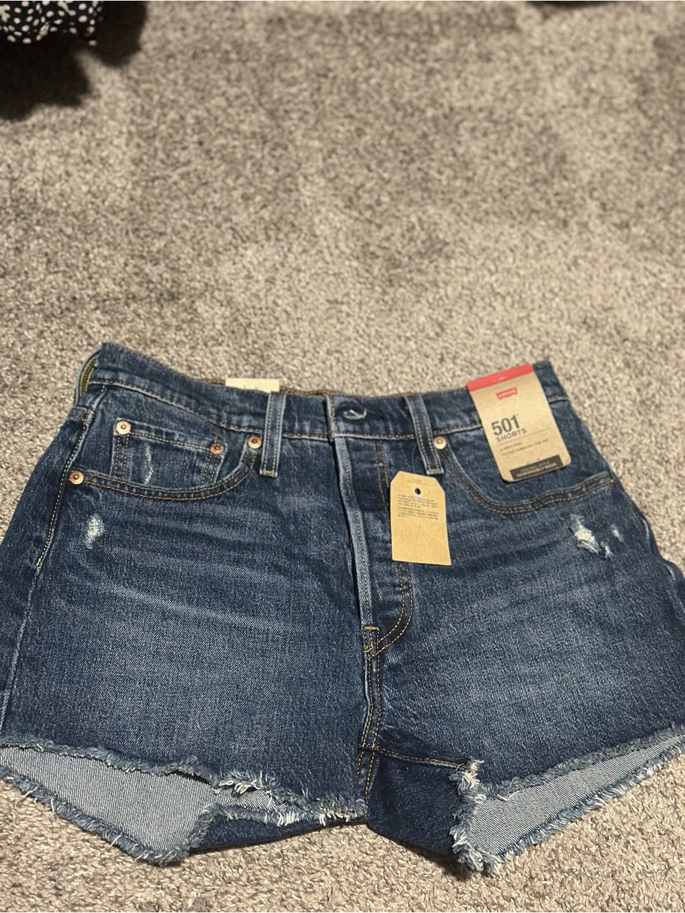 Levi's blue denim high-rise jeans with tan leather patch